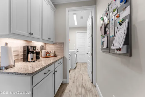 a kitchen with stainless steel appliances granite countertop a refrigerator a sink and dishwasher