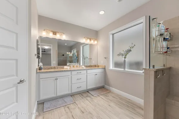 a spacious bathroom with a granite countertop sink a mirror and a