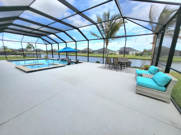 a view of a swimming pool with a couches in a patio