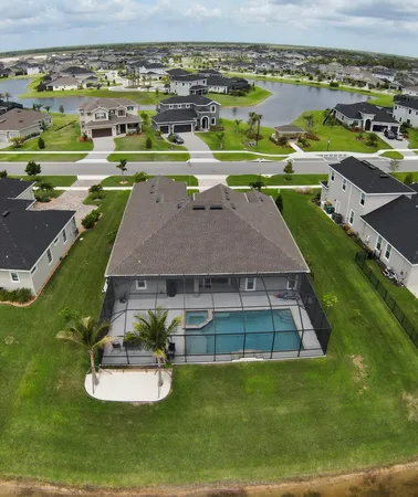 an aerial view of a house with a big yard