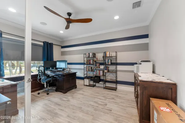 a living room with furniture a air conditioner and a window