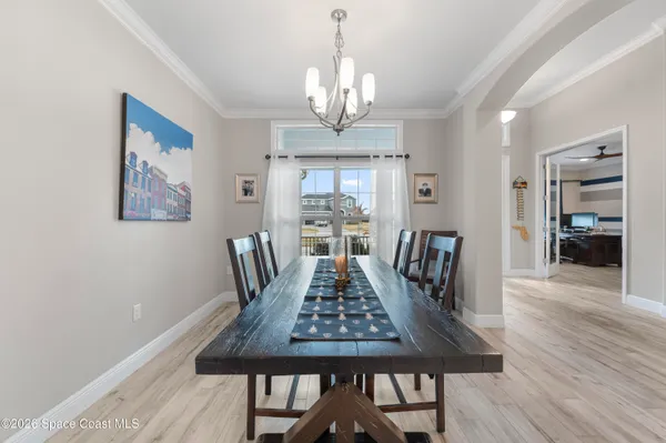 a view of a dining room with furniture wooden floor and chandelier