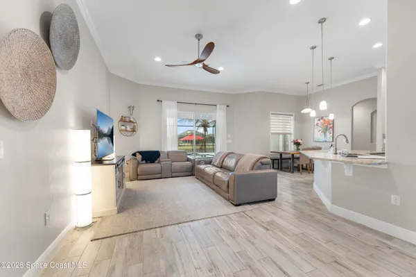 a living room with furniture and a wooden floor