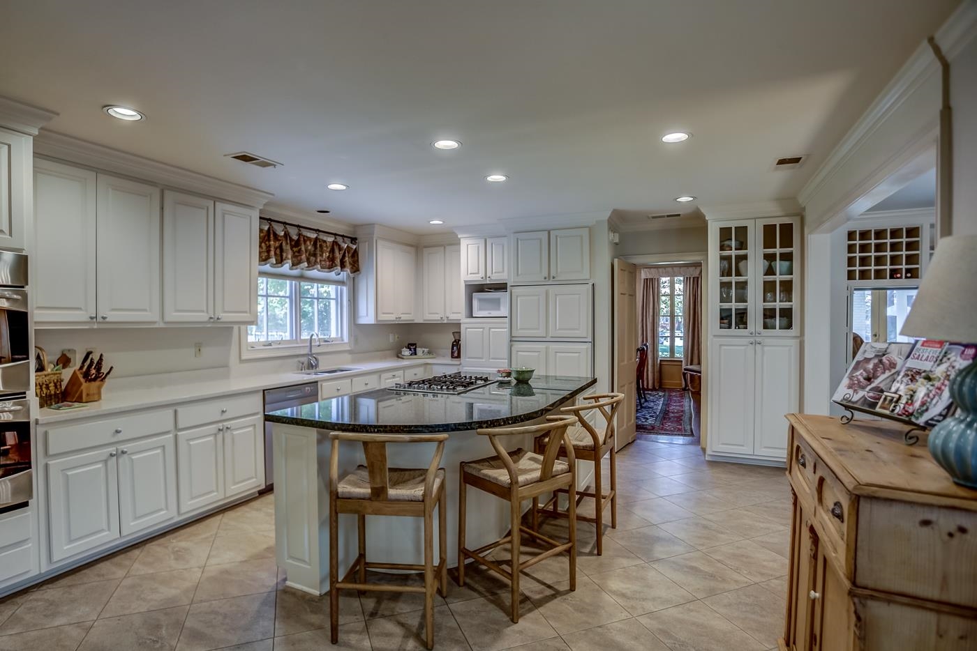 4481 Barfield Road Memphis, TN 38117 - Photo 10 of 32 a kitchen with stainless steel appliances granite countertop a table and chairs in it