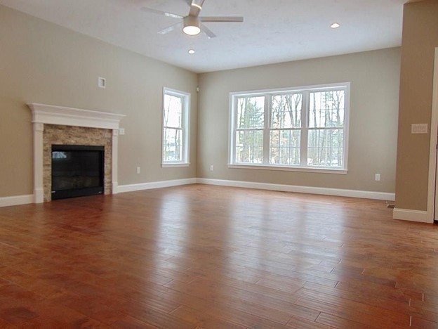 40 Green Street Foxboro, MA 02035 - Photo 8 of 16 an empty room with wooden floor fireplace and windows
