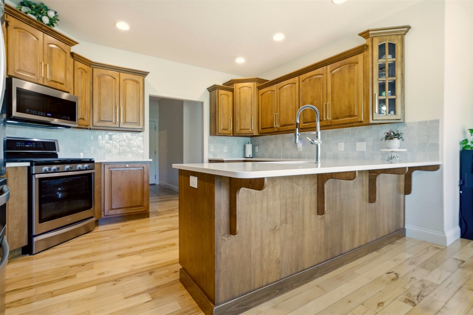 1248 Talon Lane Forsyth, IL 62535 - Photo 31 of 67 a kitchen with stainless steel appliances granite countertop a stove a sink and a microwave
