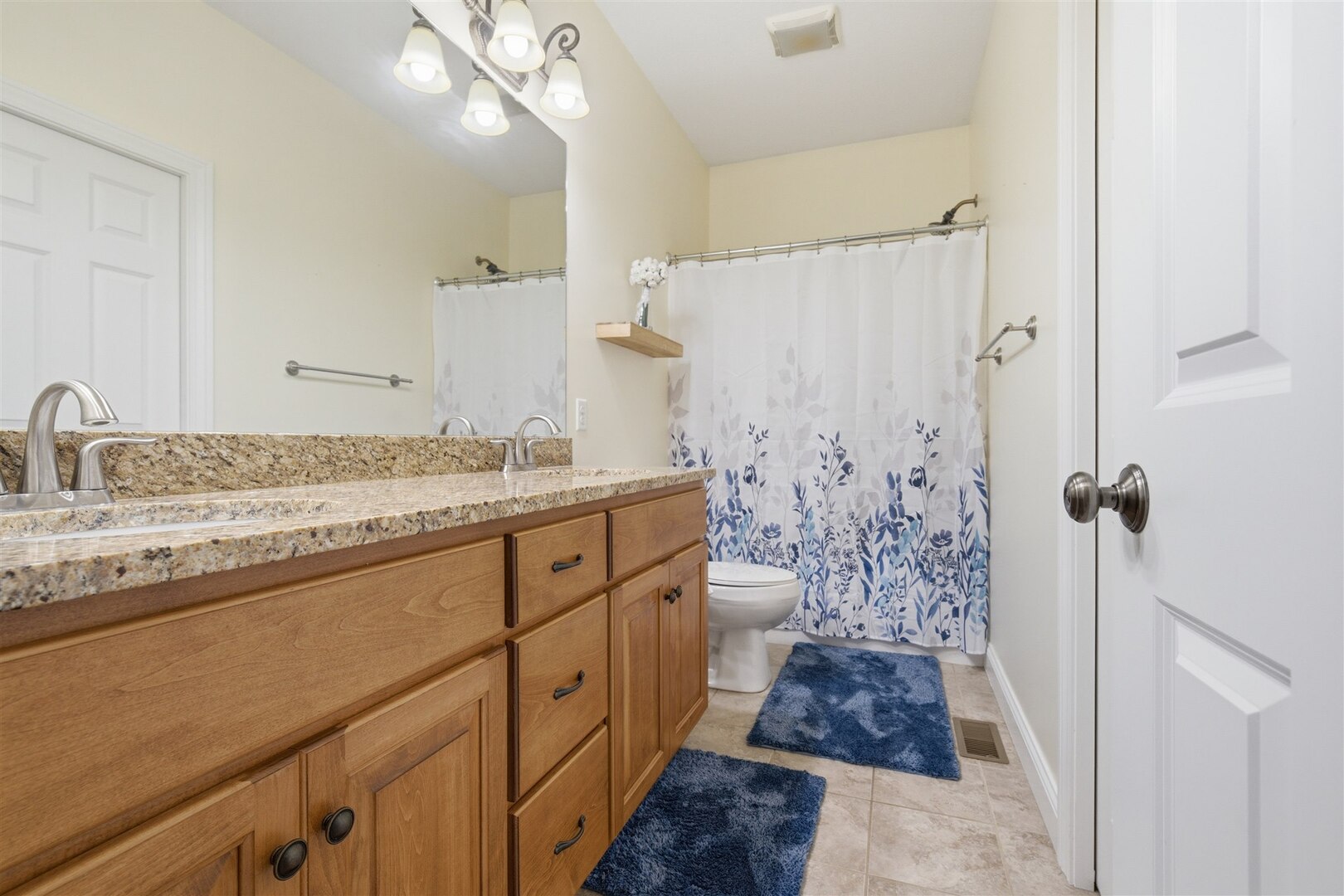 1248 Talon Lane Forsyth, IL 62535 - Photo 44 of 67 a bathroom with a granite countertop sink a toilet a mirror and shower