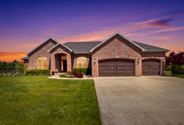 1248 Talon Lane Forsyth, IL 62535 - Photo 55 of 67 a front view of a house with yard and garage