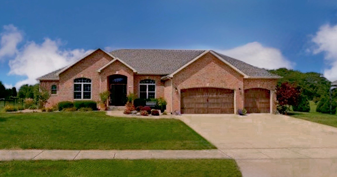 1248 Talon Lane Forsyth, IL 62535 - Photo 57 of 67 a front view of a house with a yard and garage