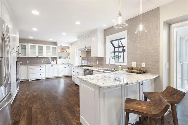 a living room with furniture or couch and a chandelier