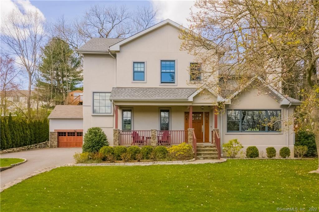 a front view of a house with a garden and plants