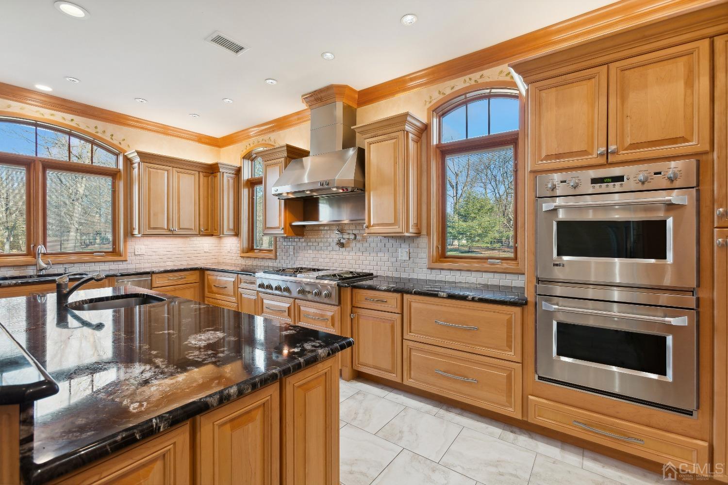 6 Longview Road Edison, NJ 08820 - Photo 24 of 74 a kitchen with stainless steel appliances granite countertop a stove a sink and a microwave