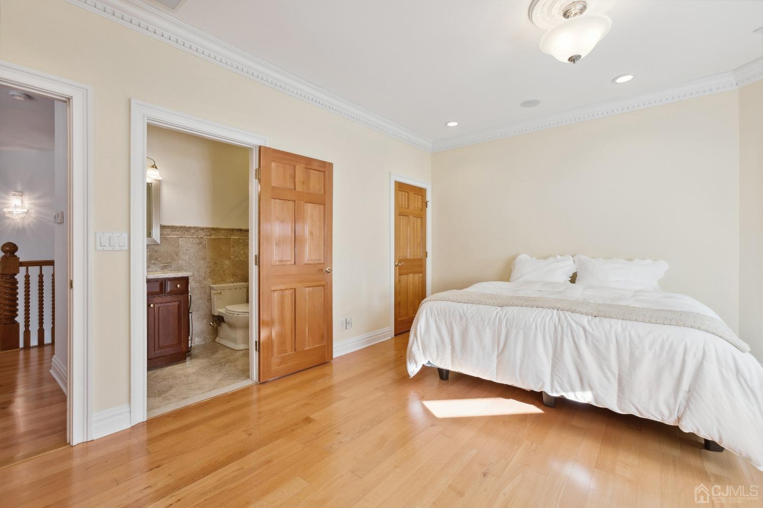 6 Longview Road Edison, NJ 08820 - Photo 44 of 74 a spacious bedroom with a bed and wooden floor