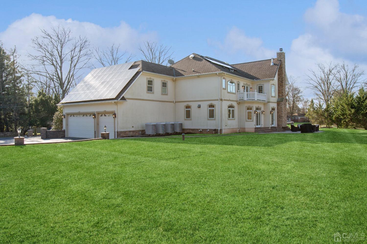 6 Longview Road Edison, NJ 08820 - Photo 54 of 74 a view of a white house with a big yard and large trees
