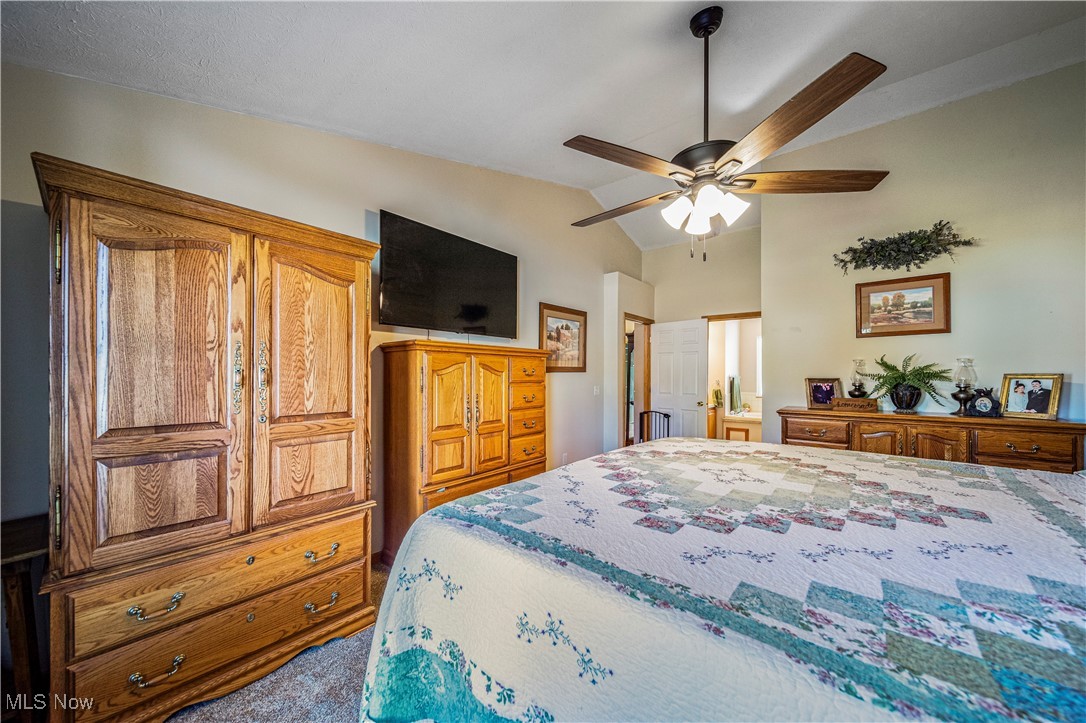 1951 Haines Road Madison, OH 44057 - Photo 19 of 44 Carpeted bedroom featuring ceiling fan and vaulted ceiling