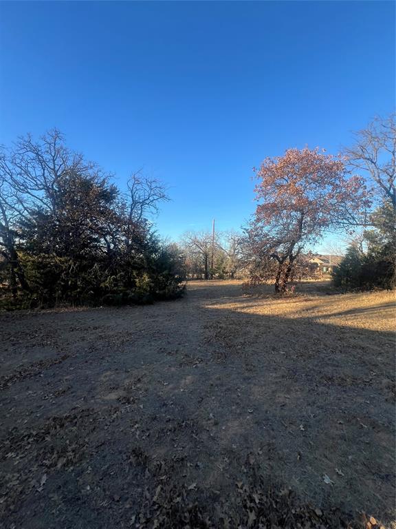 6901 Hawk Road Flower Mound, TX 75022 - Photo 17 of 24 a view of dirt field with trees in background