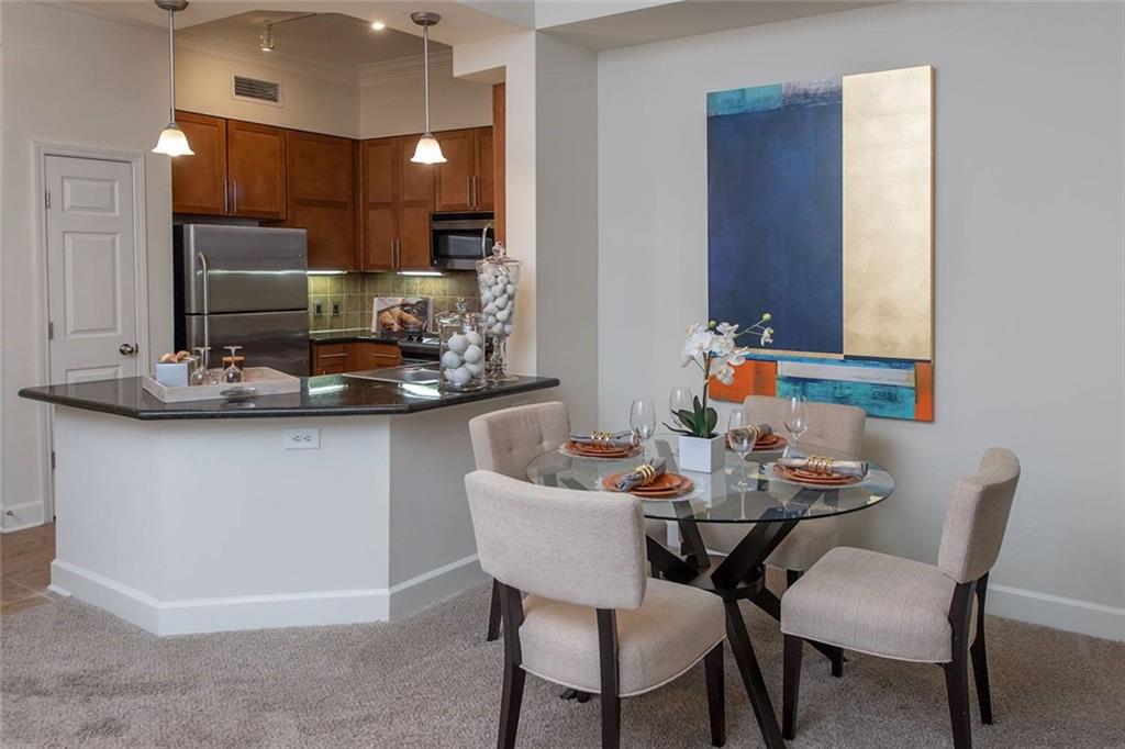 3443 Kingsboro Road Northeast, Unit 1309 Atlanta, GA 30326 - Photo 2 of 17 a dining room with furniture and wooden floor
