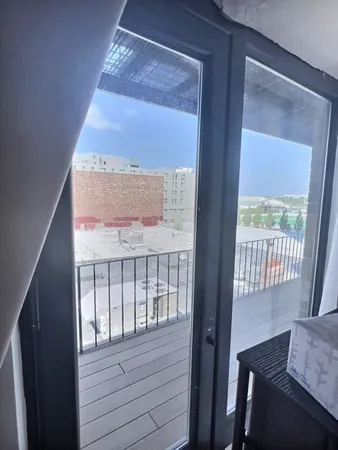 a view of balcony with wooden floor