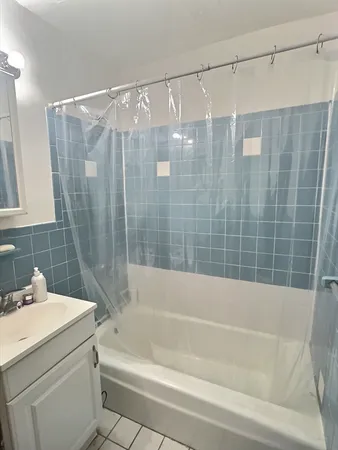 a bathroom with a shower curtain and a bathtub