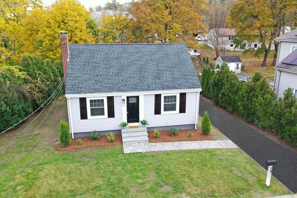 2 A Circular Avenue Natick, MA 01760 - Photo 2 of 29 a front view of house with yard and trees in the background