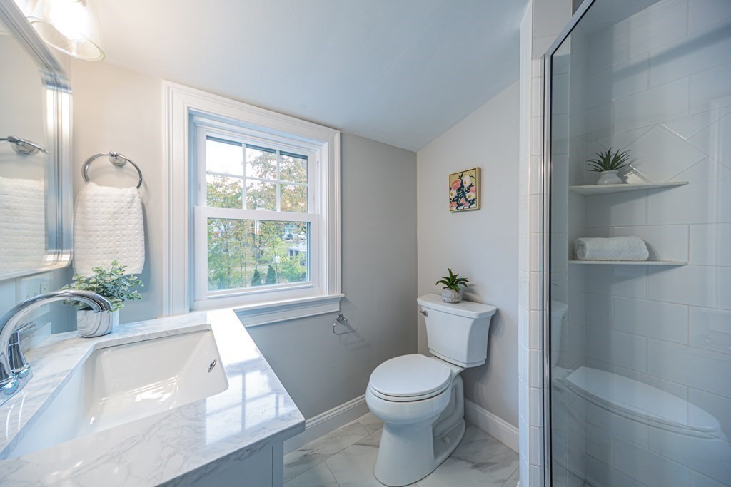 2 A Circular Avenue Natick, MA 01760 - Photo 21 of 29 a white toilet sitting next to a bathroom sink and tub