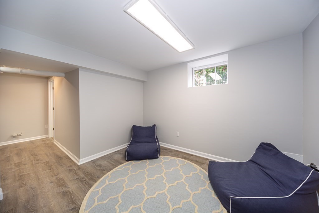 2 A Circular Avenue Natick, MA 01760 - Photo 22 of 29 a bedroom with a bed and a chair