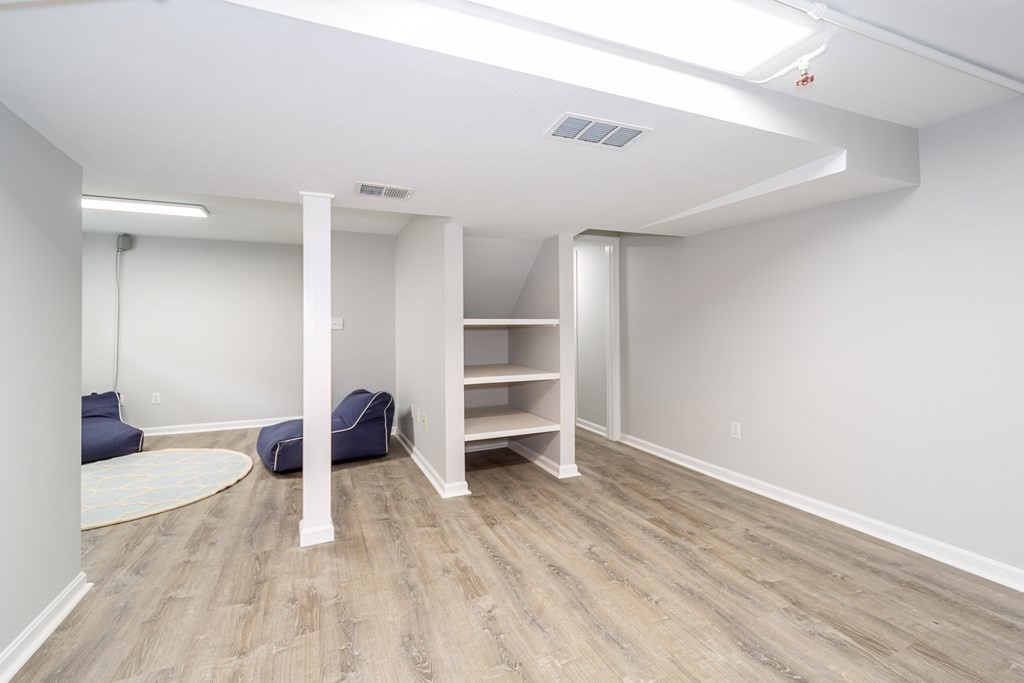 2 A Circular Avenue Natick, MA 01760 - Photo 25 of 29 a view of an empty room with a window and wooden floor