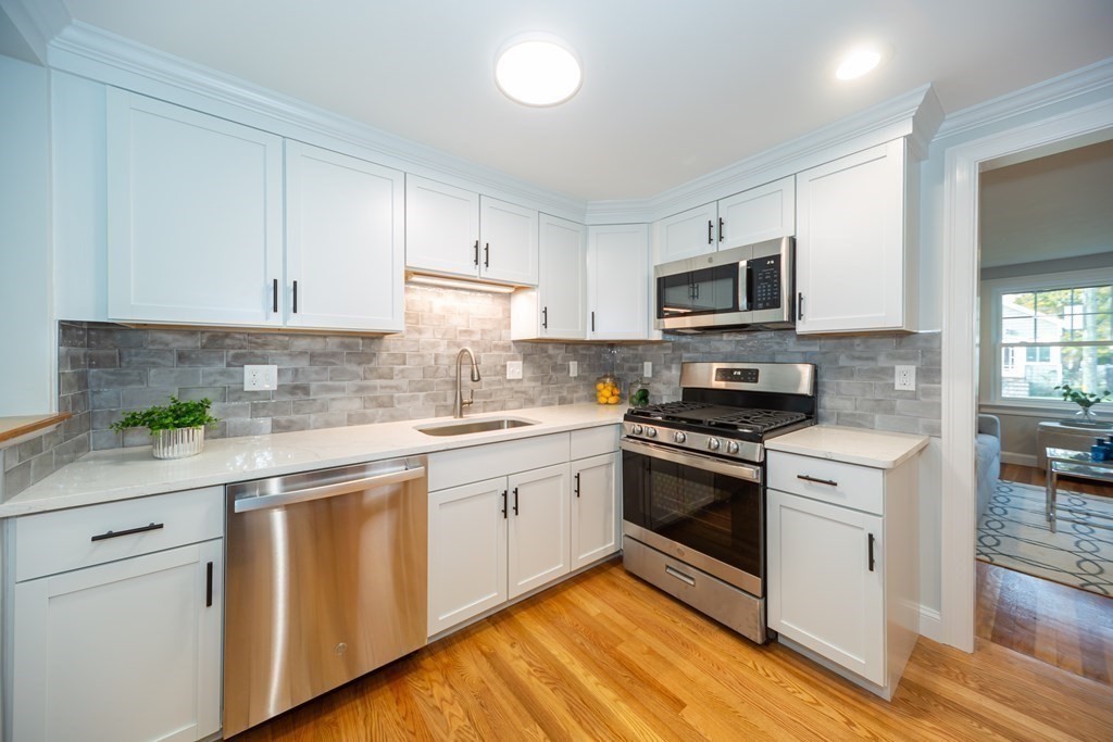 2 A Circular Avenue Natick, MA 01760 - Photo 9 of 29 a kitchen with white cabinets stainless steel appliances and sink