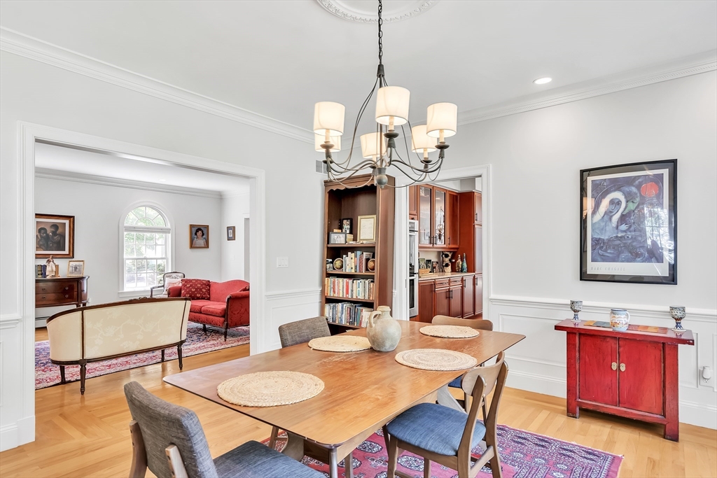 34 Solomon Pierce Road Lexington, MA 02420 - Photo 10 of 42 a view of a dining room with furniture a chandelier and wooden floor