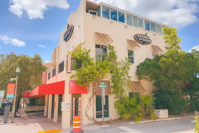 a front view of a building with street sign