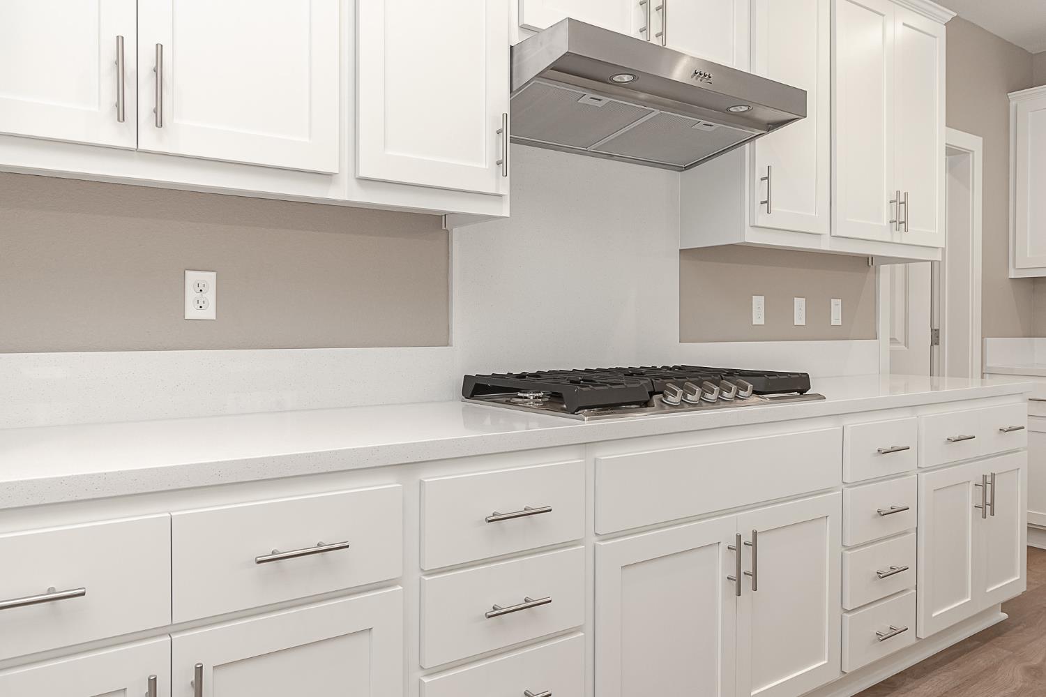 1310 Veteran Street Manteca, CA 95337 - Photo 12 of 33 a stove top oven sitting inside of a kitchen