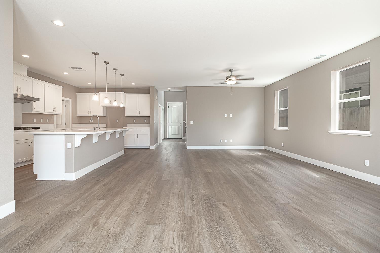 1310 Veteran Street Manteca, CA 95337 - Photo 19 of 33 a large kitchen with cabinets wooden floor and stainless steel appliances