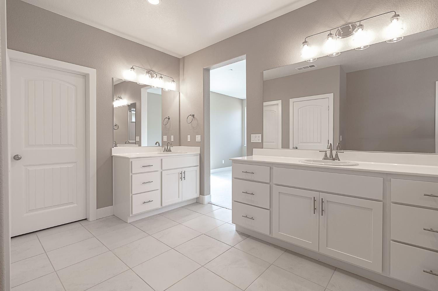 1310 Veteran Street Manteca, CA 95337 - Photo 22 of 33 a spacious bathroom with double sink and a mirror