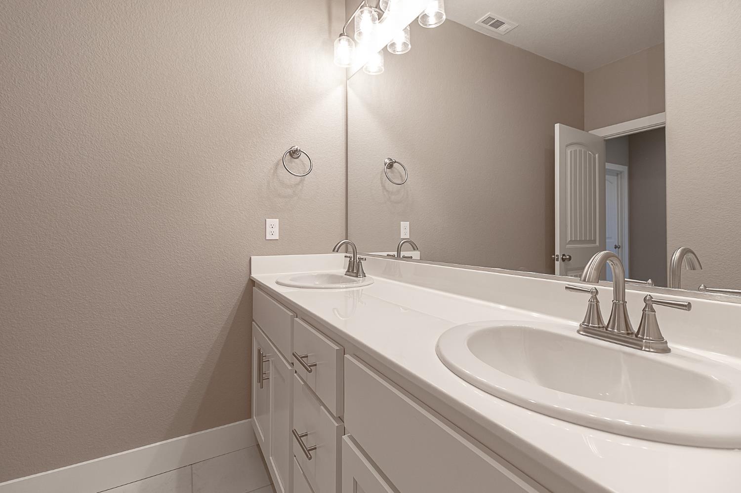 1310 Veteran Street Manteca, CA 95337 - Photo 29 of 33 a bathroom with a sink and a mirror