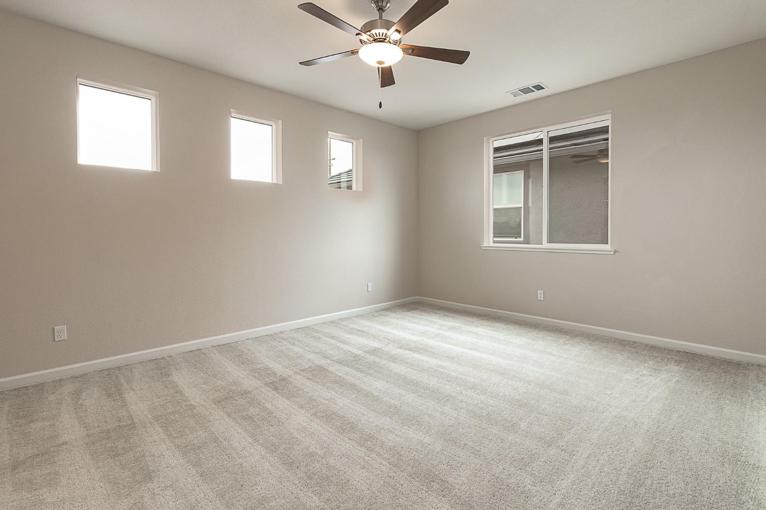 1310 Veteran Street Manteca, CA 95337 - Photo 33 of 33 an empty room with windows and fan