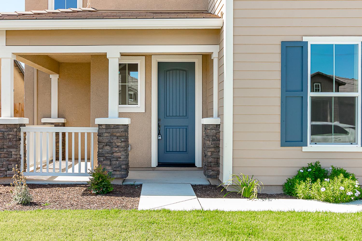 1310 Veteran Street Manteca, CA 95337 - Photo 4 of 33 a front view of a house with a yard