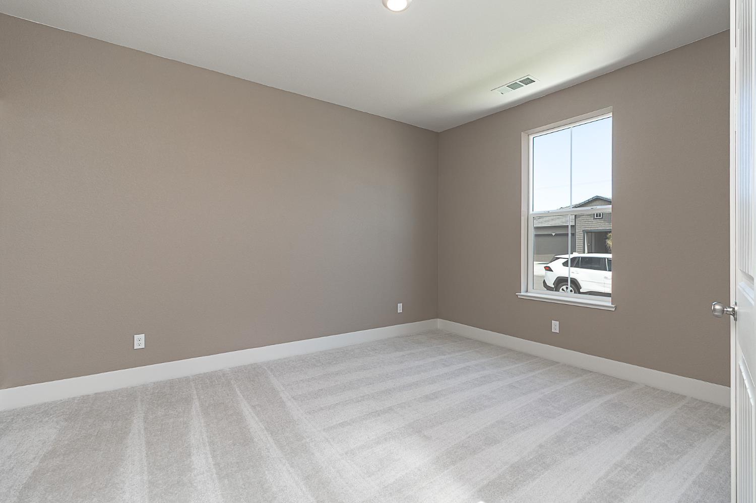 1310 Veteran Street Manteca, CA 95337 - Photo 6 of 33 a view of an empty room with a window