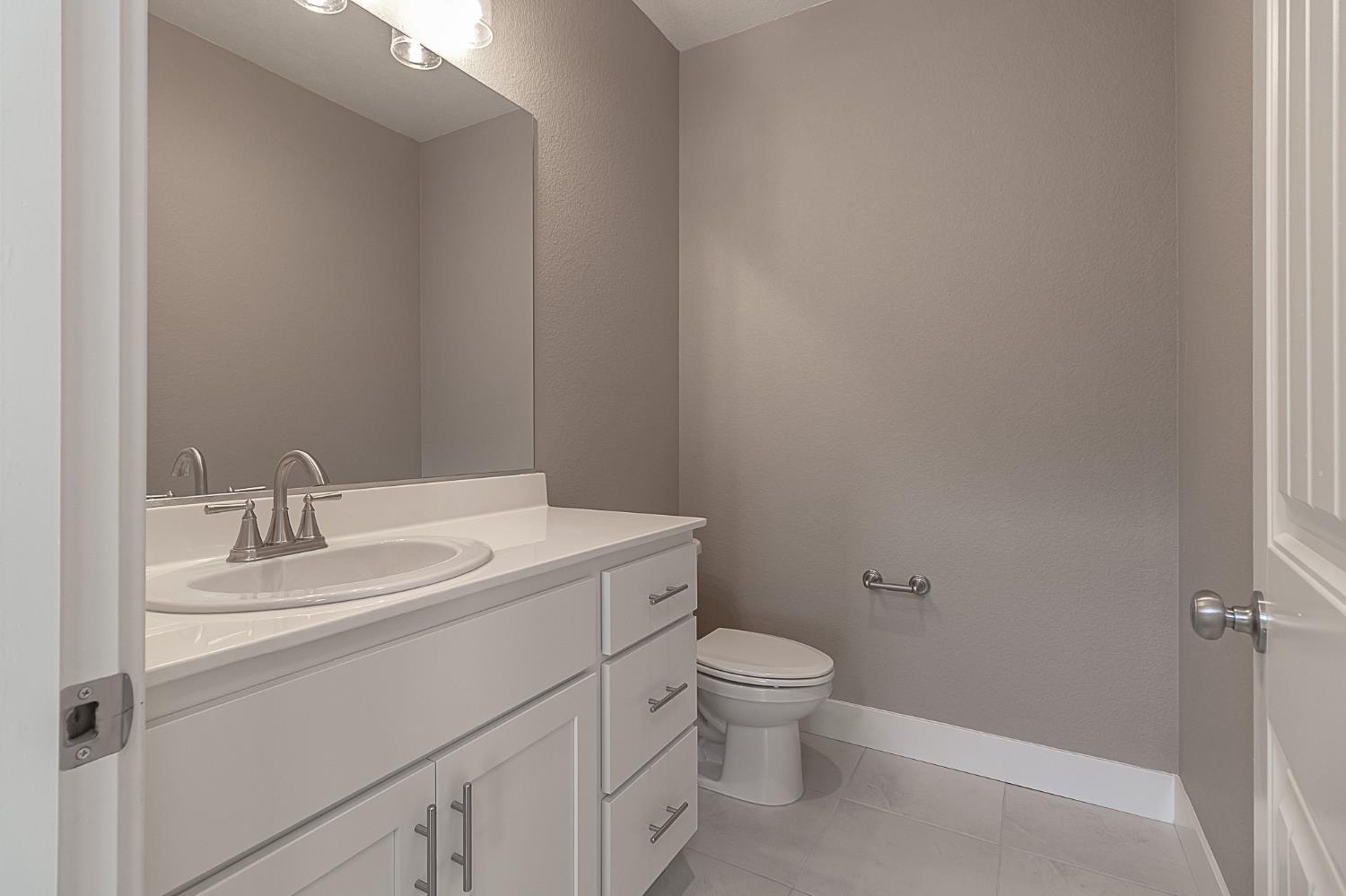 1310 Veteran Street Manteca, CA 95337 - Photo 8 of 33 a bathroom with a sink toilet and vanity