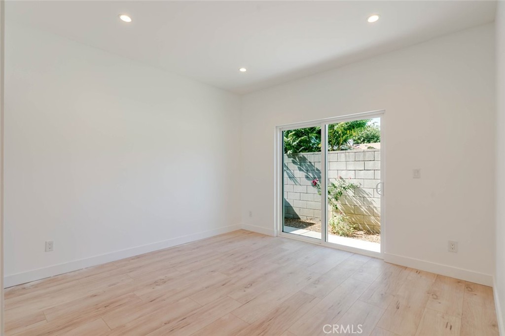 6835 Yolanda Avenue Reseda, CA 91335 - Photo 11 of 34 an empty room with wooden floor and windows