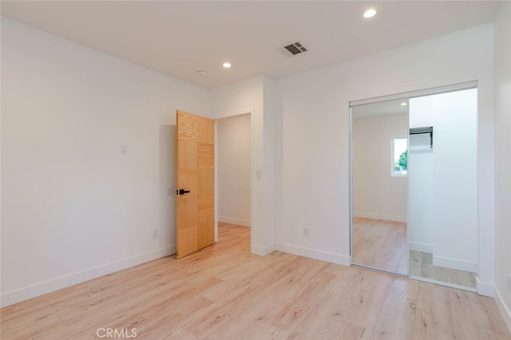 6835 Yolanda Avenue Reseda, CA 91335 - Photo 18 of 34 an empty room with wooden floor and mirror