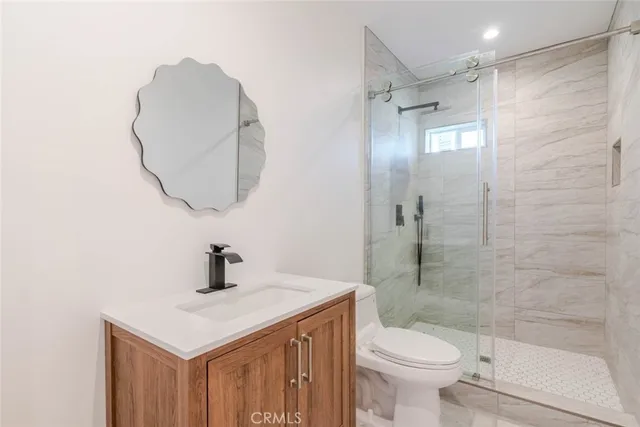 a bathroom with a sink toilet and shower