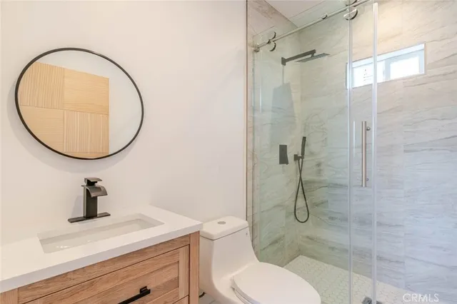 a bathroom with a toilet a sink and a mirror