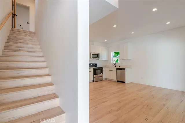 a view of a kitchen with microwave and refrigerator