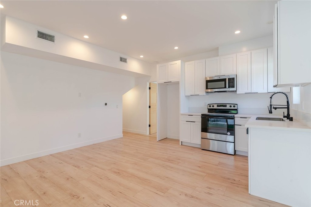 6835 Yolanda Avenue Reseda, CA 91335 - Photo 5 of 34 a kitchen with kitchen island a sink stainless steel appliances and cabinets