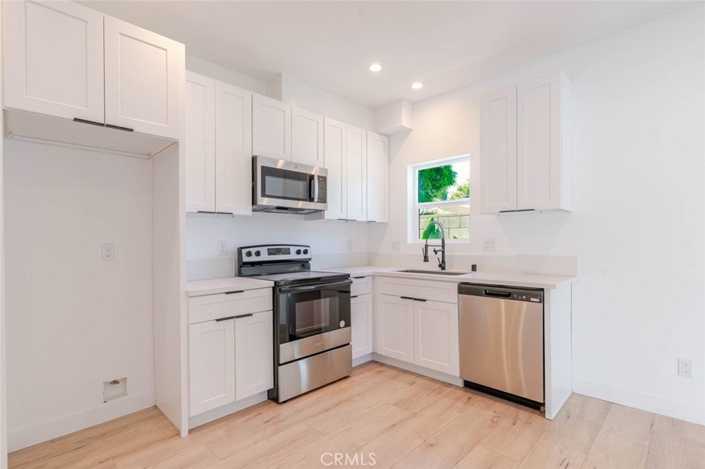 6835 Yolanda Avenue Reseda, CA 91335 - Photo 8 of 34 a kitchen with a sink cabinets and stainless steel appliances
