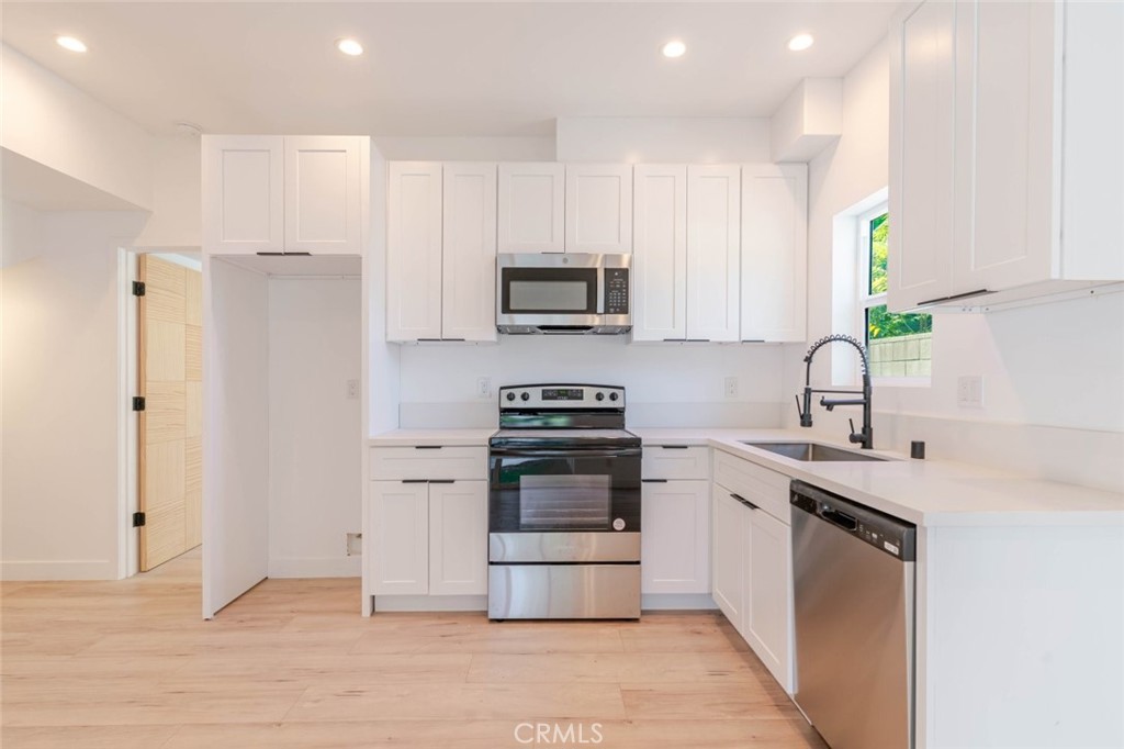 6835 Yolanda Avenue Reseda, CA 91335 - Photo 9 of 34 a kitchen with a stove a sink and a refrigerator