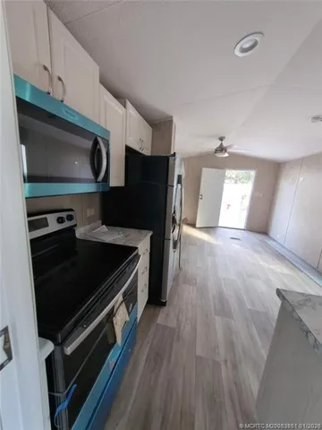 a kitchen with stainless steel appliances a stove a microwave and cabinets