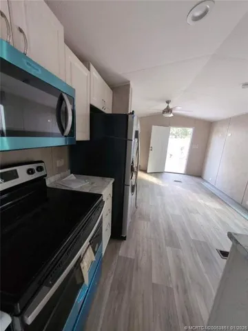 a kitchen with wooden floors and a stove