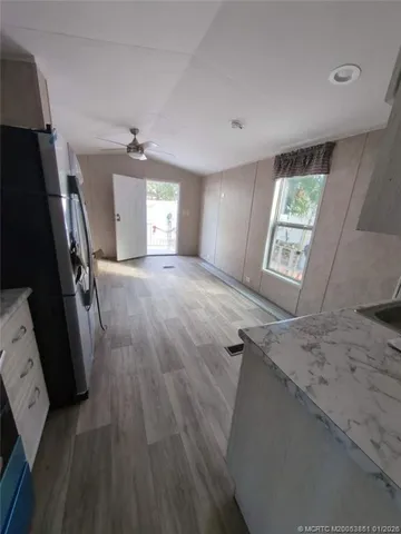 a view of empty room with windows and wardrobe