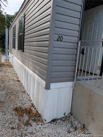 a view of a house with wooden fence